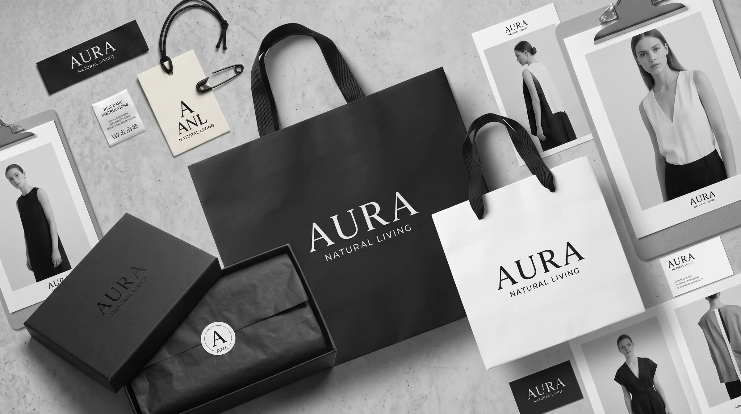 Branded packaging set in black and white: shopping bags, gift box with tissue and seal, hang tag, woven label and printed cards